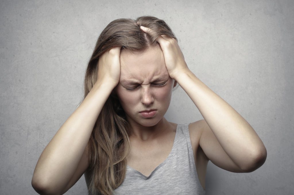 woman in gray tank top showing distress